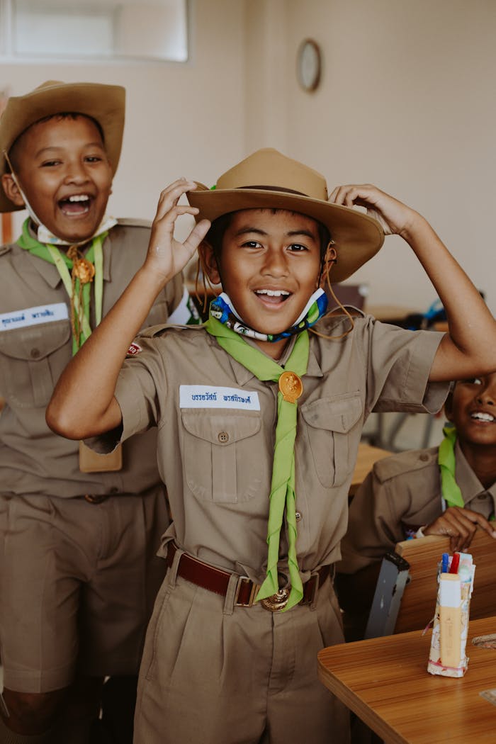 Happy Thai students in scout uniforms, smiling and playing, capturing joyful school life.